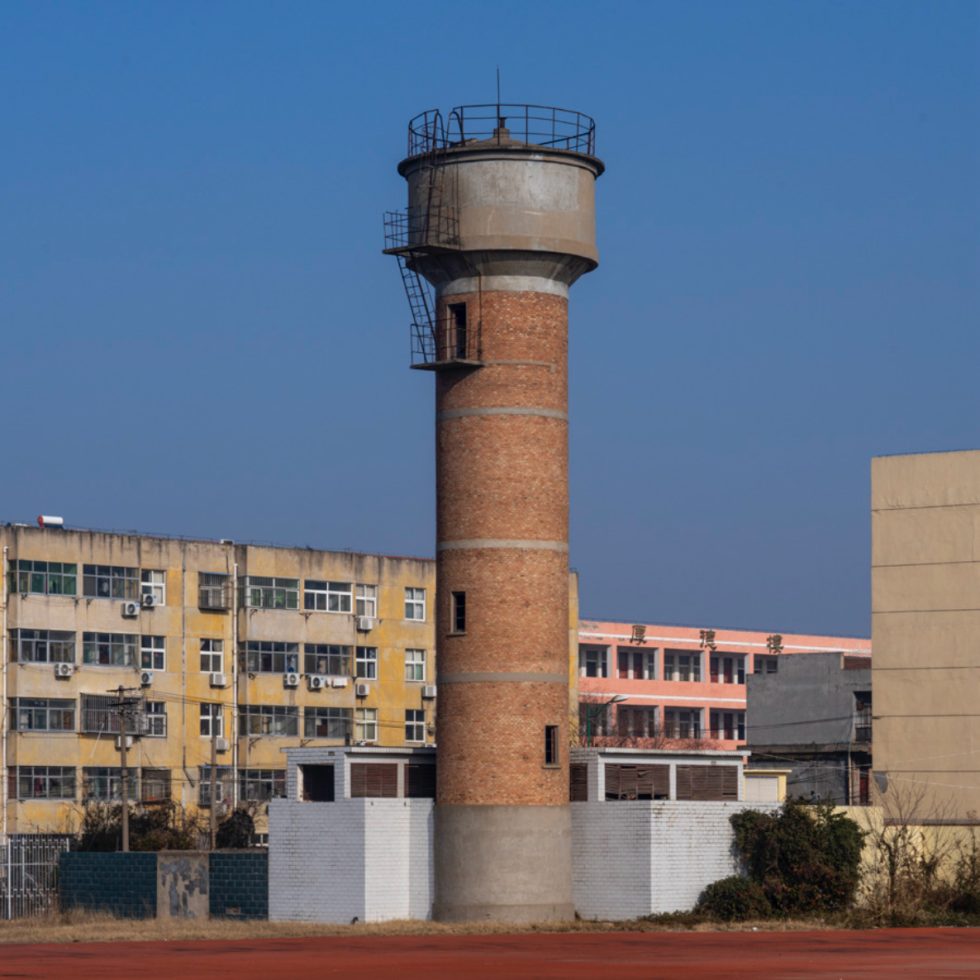 This is a color photograph of a brick watertower.